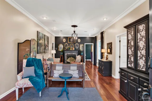 a living room with furniture large window and wooden floor