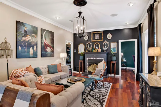 a living room with furniture a dining table and a chandelier