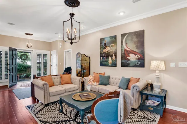 a living room with furniture a rug and a chandelier