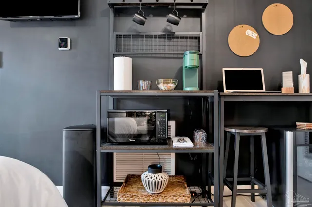 a kitchen with a refrigerator and a fireplace