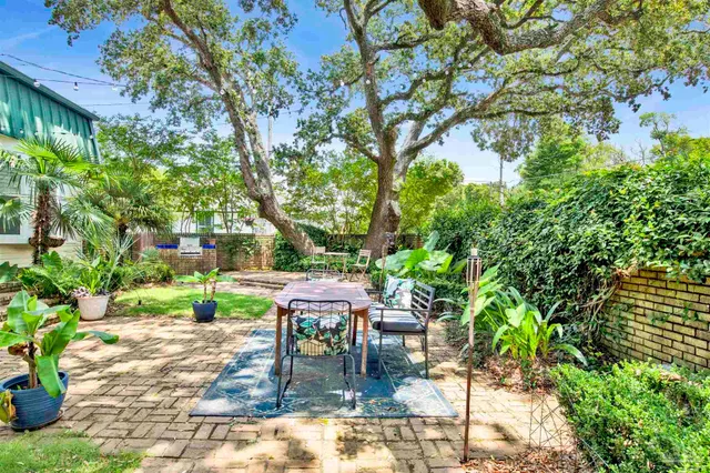 a backyard of a house with table and chairs