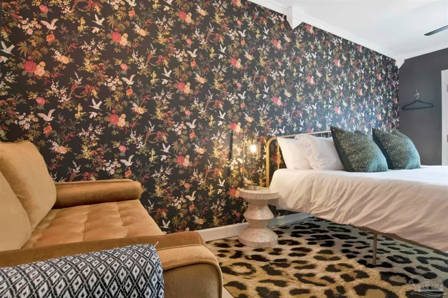 a bedroom with a bed and a couch