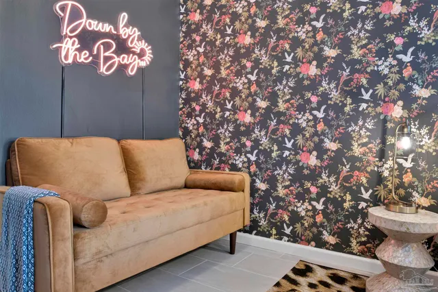 a blue couch sitting next to a wooden table and chair