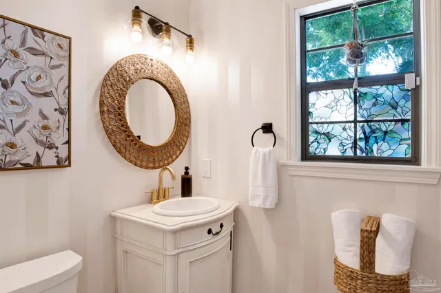 a bathroom with a sink a mirror and a toilet