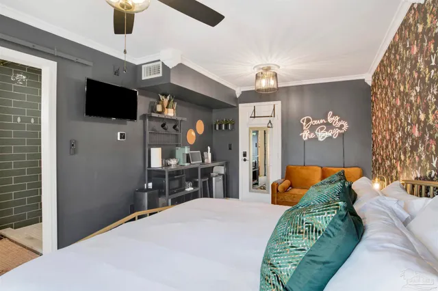 a bedroom with a bed and a flat tv screen