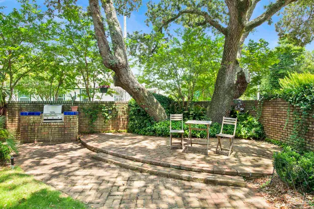 a backyard of a house with lots of green space and chair