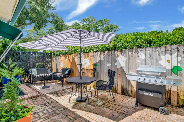 a patio with a patio table and chairs