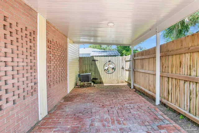 a view of backyard with table and chairs and a large tree