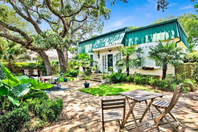 a view of an chairs and table in the patio