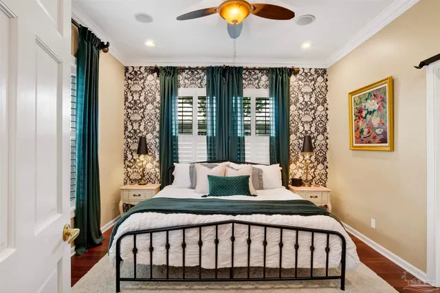 a bedroom with a large bed and a large window