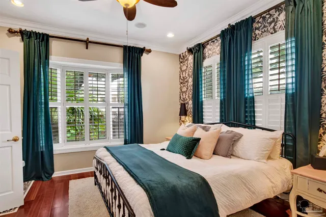 a bedroom with a large bed and a large window