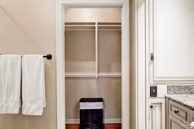 a view of a closet with wooden floor