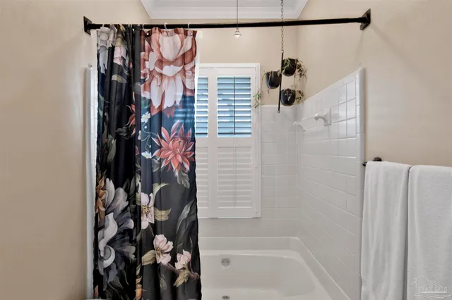 a bathroom with a bathtub and shower