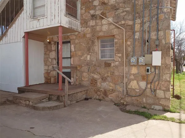 a view of a brick house with brick walls