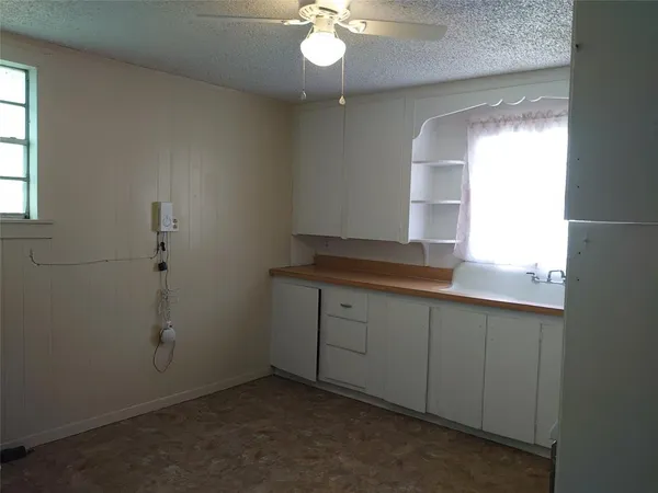 an empty room with cabinet and window