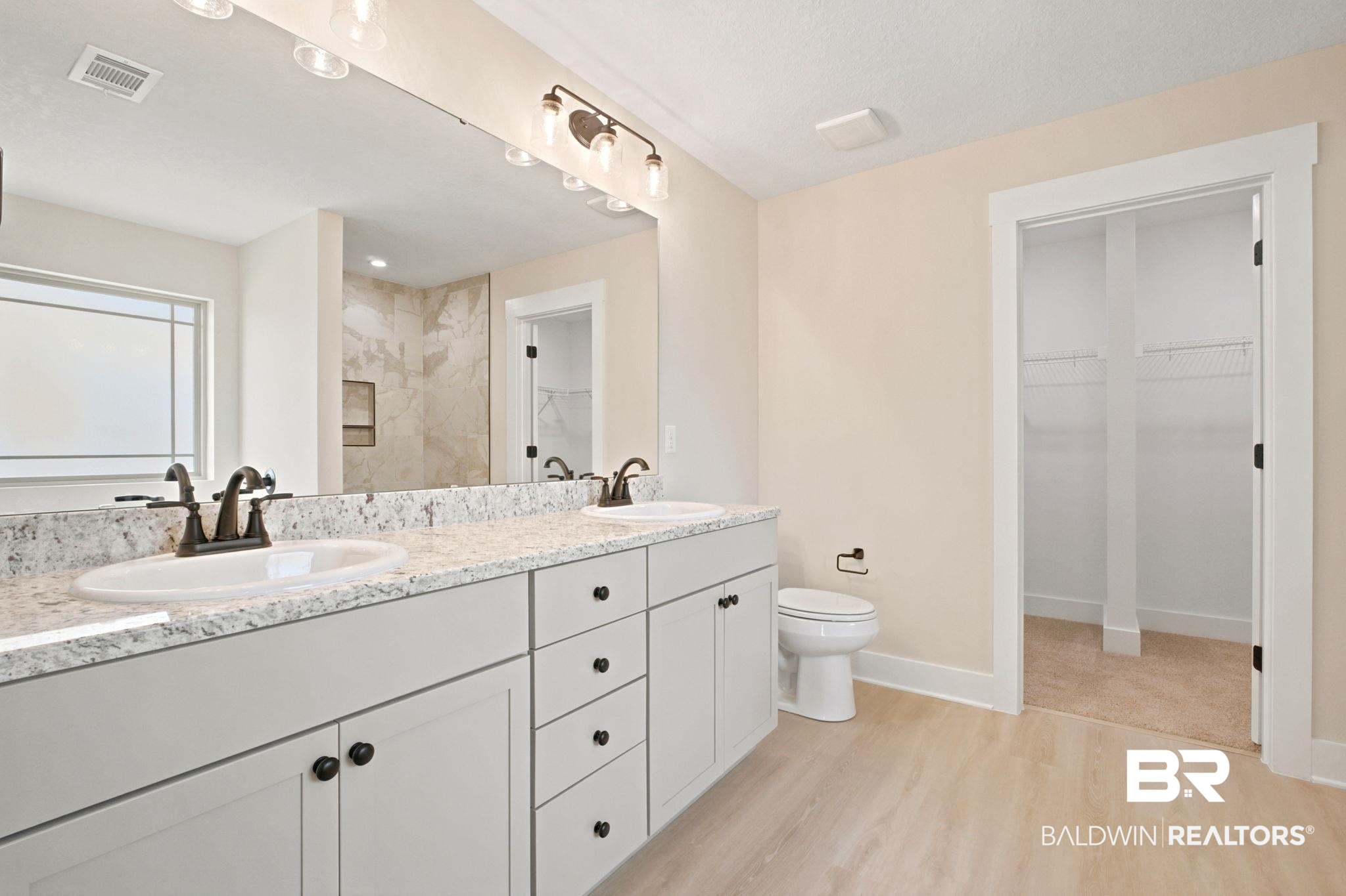 32656 Arbor Ridge Circle Lillian, AL 36549 - Photo 16 of 56 Double vanity with light-toned granite countertop, two undermount sinks, and bronze-finish faucets