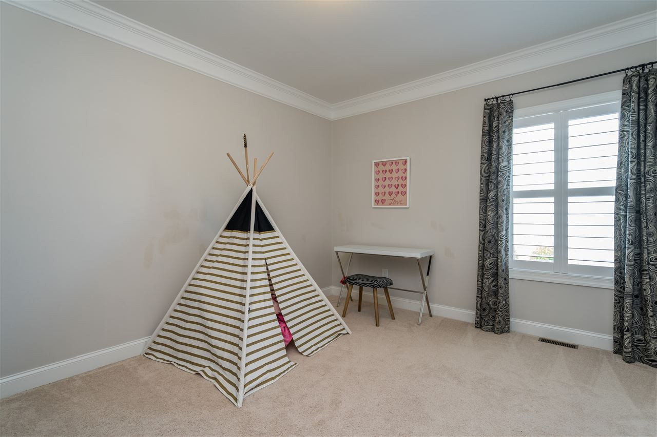 1400 Van Page Boulevard Raleigh, NC 27607 - Photo 27 of 30 Light filled bedroom with shutters and wooden shelving in the closet. Bedroom