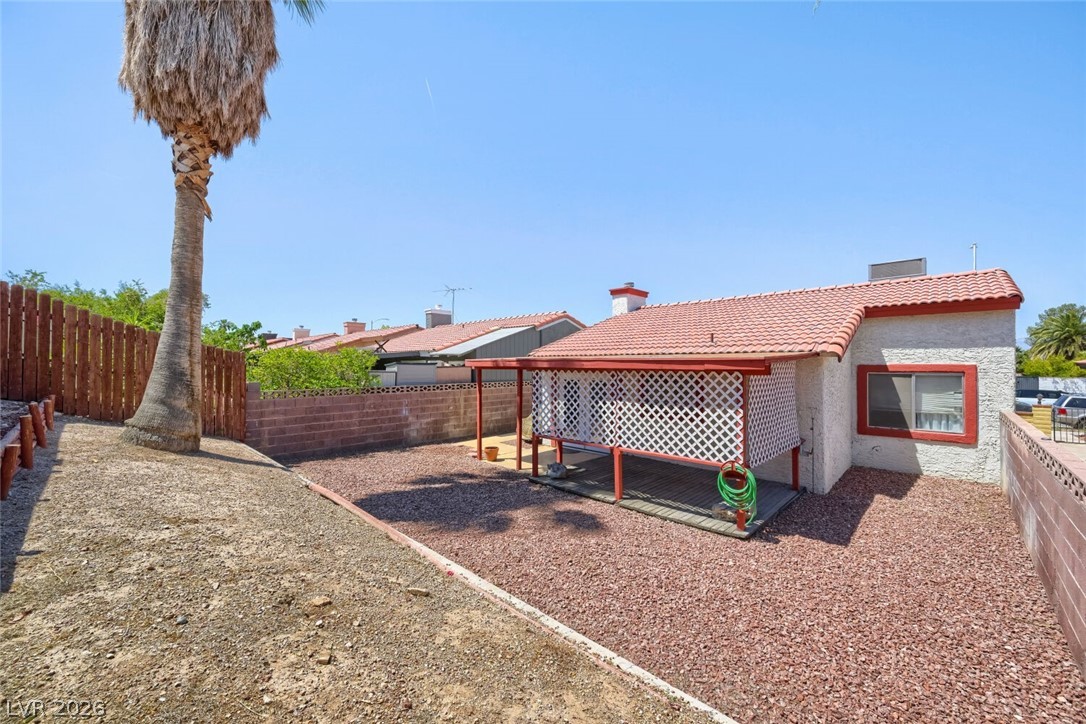 2322 Sabroso Street Las Vegas, NV 89156 - Photo 16 of 17 A backyard retreat featuring a covered patio and mature palm.