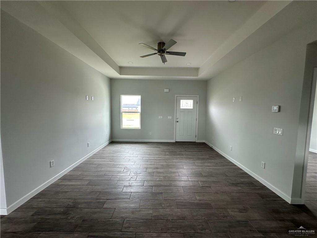 1606 Unity Drive Mercedes, TX 78570 - Photo 2 of 11 an empty room with wooden floor and windows