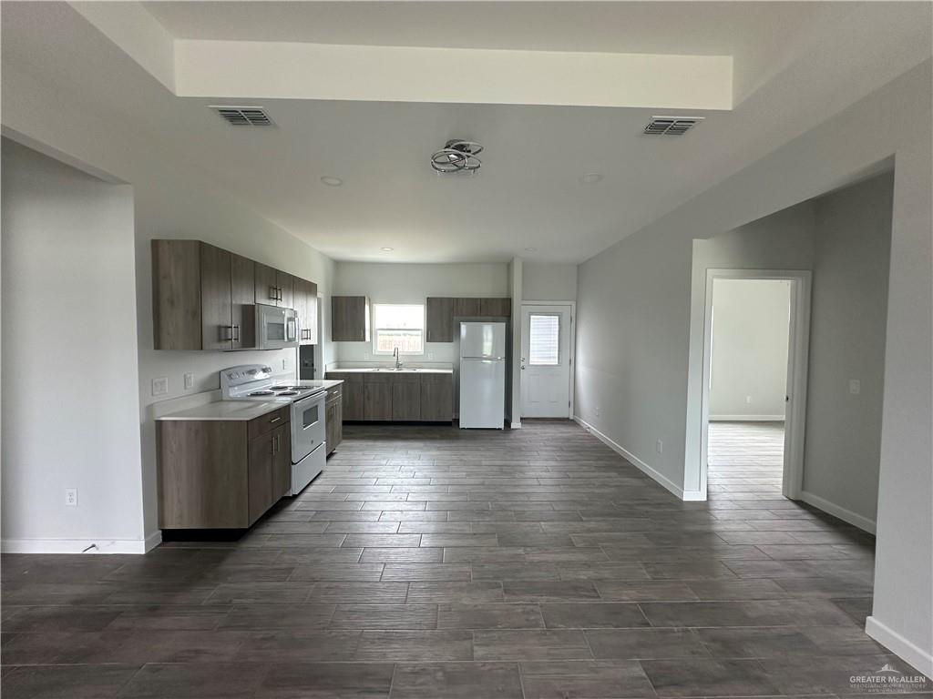 1606 Unity Drive Mercedes, TX 78570 - Photo 3 of 11 a large kitchen with a wooden floor and a large window
