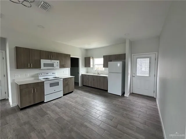a kitchen with stainless steel appliances a refrigerator and a stove top oven
