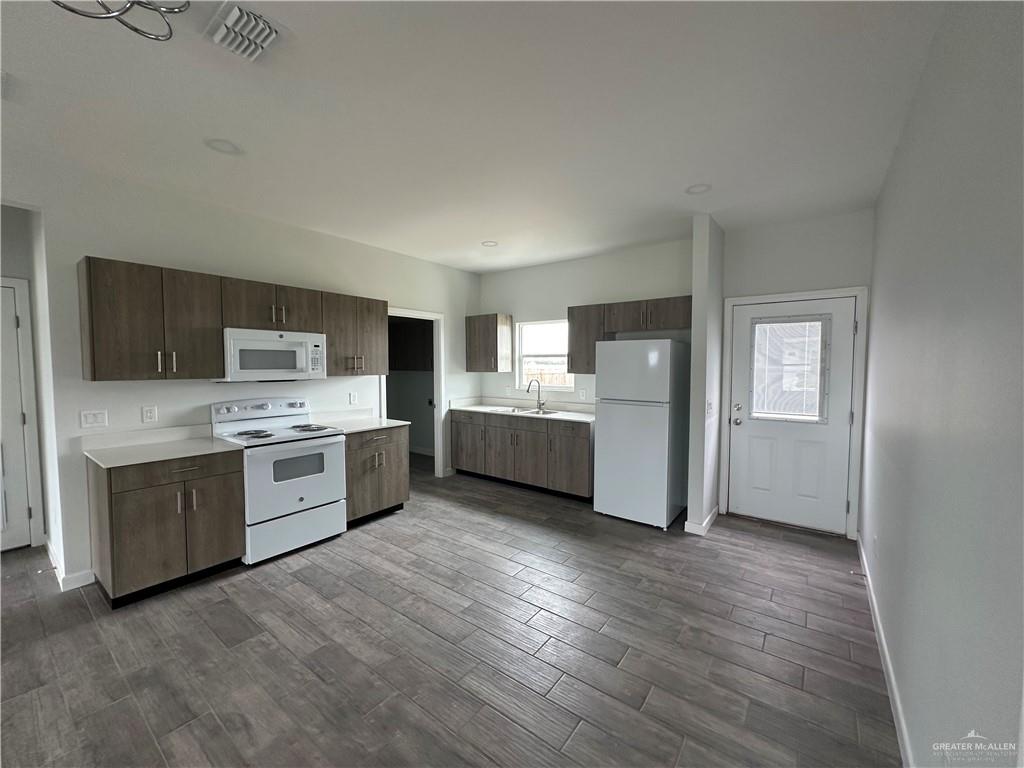1606 Unity Drive Mercedes, TX 78570 - Photo 4 of 11 a kitchen with stainless steel appliances a refrigerator and a stove top oven