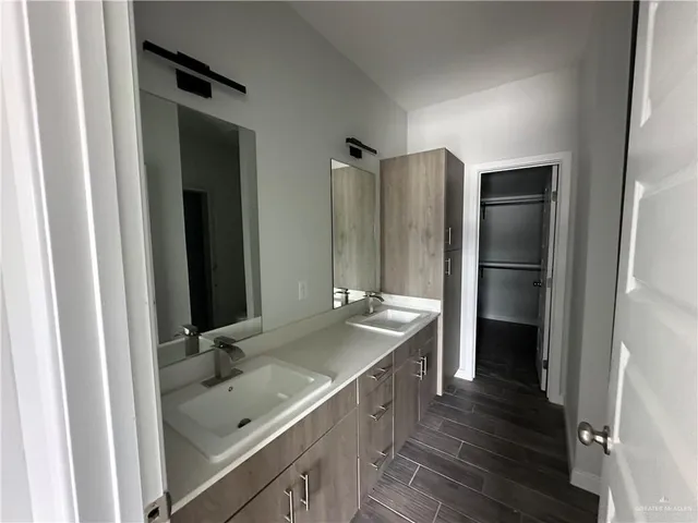 a bathroom with a double vanity sink and mirror