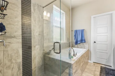 a bathroom with a bathtub and a shower