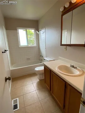 a bathroom with a double vanity sink toilet mirror and bathtub