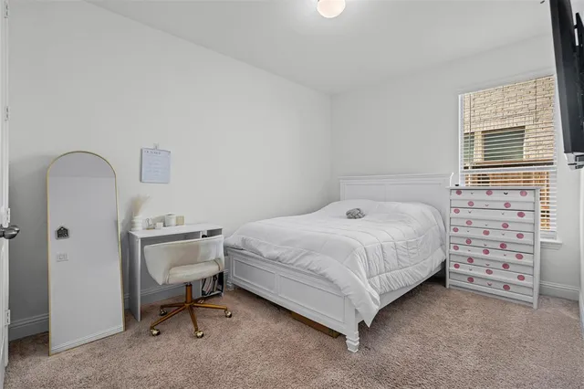 a bedroom with a bed and a chair