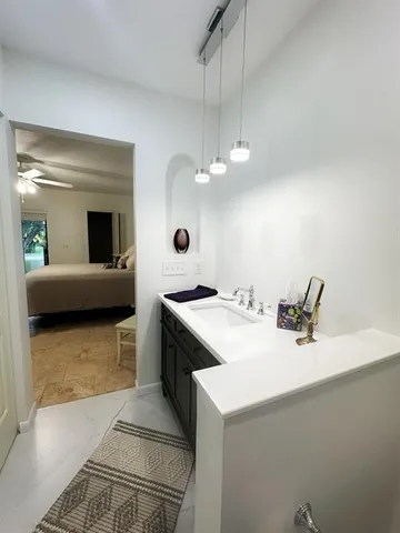 a kitchen with a sink and a stove top oven