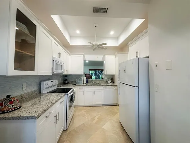 a kitchen with refrigerator and cabinets
