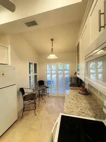 a living room with fireplace furniture and a large window