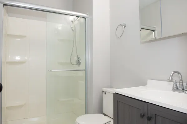 a bathroom with a shower toilet and sink