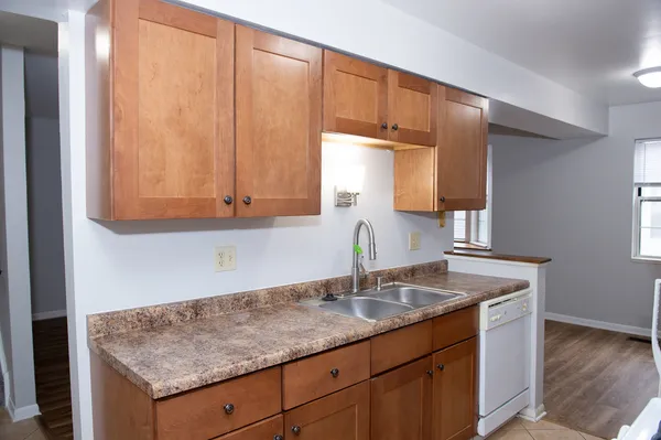 a kitchen with a sink cabinets and a window