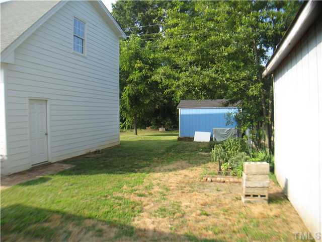 3119 Stanhope Avenue Raleigh, NC 27607 - Photo 17 of 18 a backyard of a house with plants and large tree