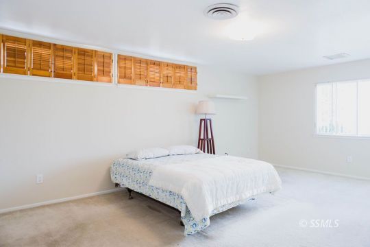 712 Peg Street Ridgecrest, CA 93555 - Photo 20 of 44 a bedroom with a bed and next to a window