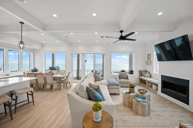 a living room with furniture and kitchen view