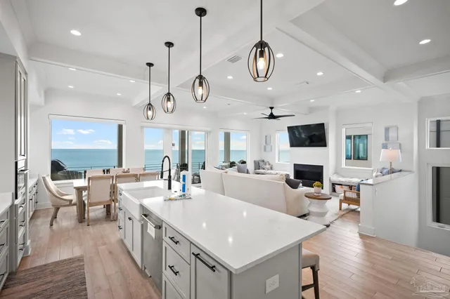 a kitchen with white cabinets and a wooden floor