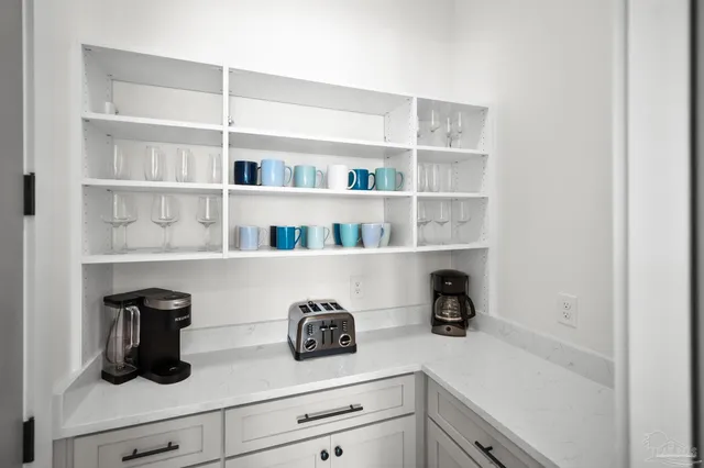a large kitchen with a table and chairs