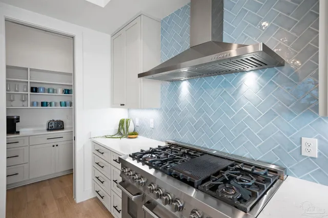a dining room with furniture and large windows