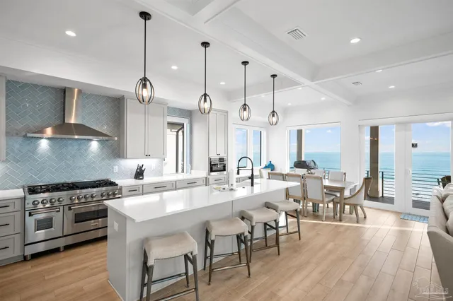 a kitchen with stainless steel appliances a stove a refrigerator and cabinets