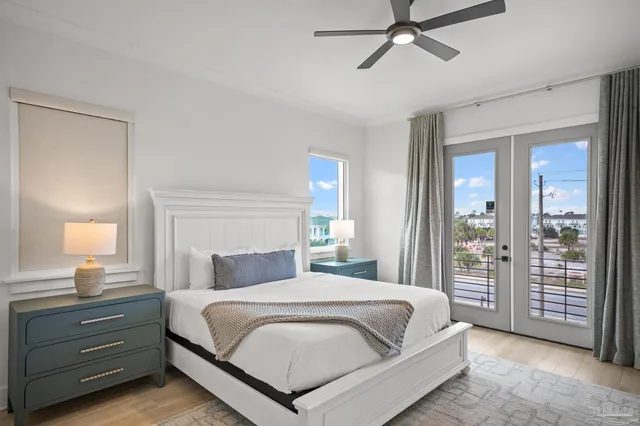 a living room with furniture a flat screen tv and a large window