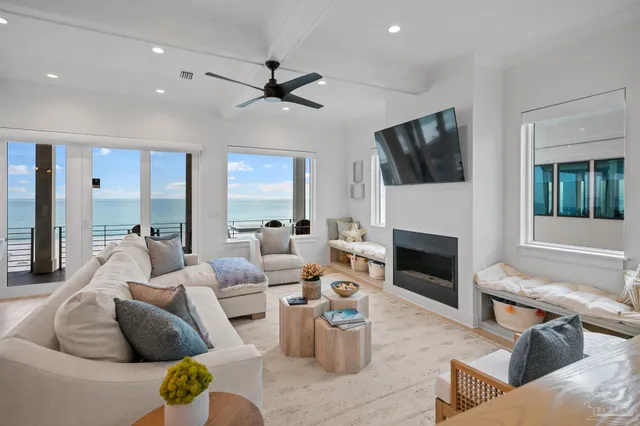 a living room with furniture a fireplace and a flat screen tv
