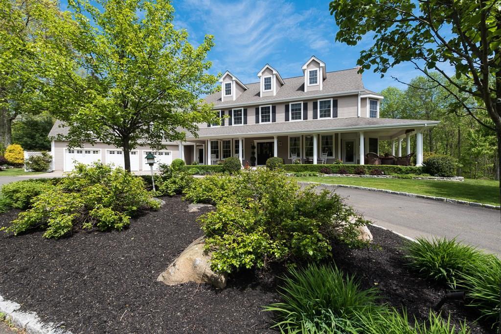 a front view of a house with a yard and shrubs