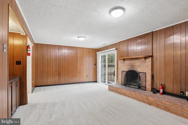 an empty room with fireplace and windows