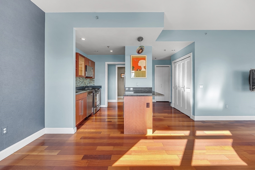 17 Otis Street, Unit 602 Cambridge, MA 02141 - Photo 26 of 40 a hallway with wooden floor and windows