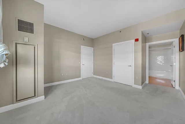a spacious bathroom with a granite countertop sink a toilet a mirror and shower