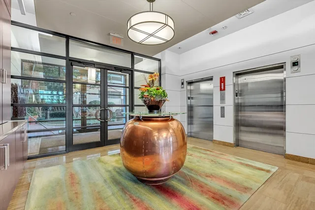 a view of a livingroom with wooden floor and a large window
