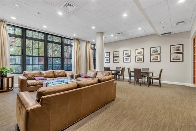 a living room with furniture and large windows